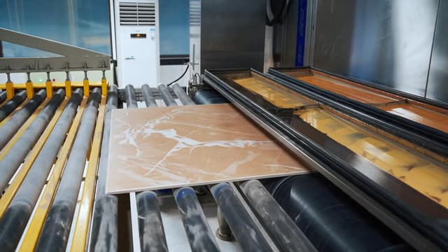 Ceramic tile moving through a production line at Ceraglow's Foshan manufacturing base