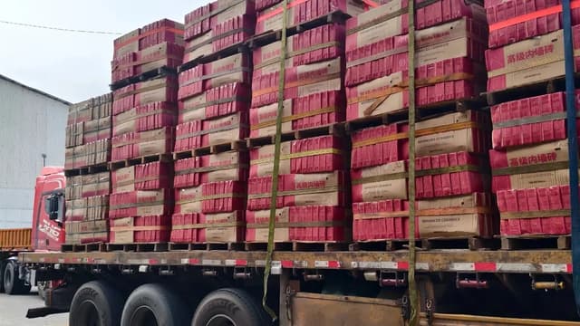 Palletized ceramic tile cartons secured on a truck for export shipment