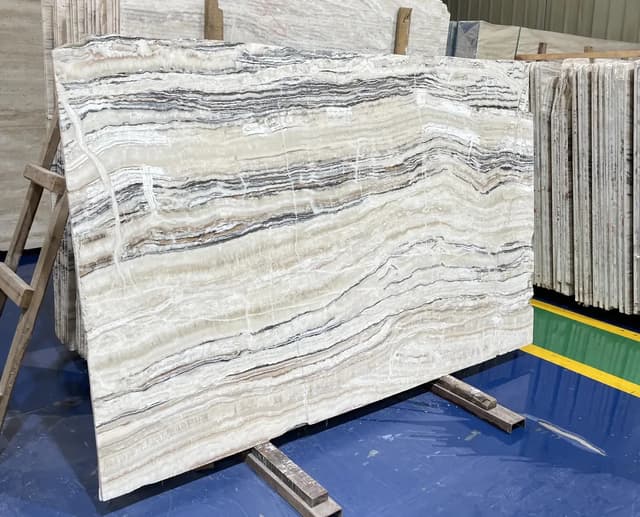 Large-format veined slab displayed upright for colour and pattern review at Ceraglow