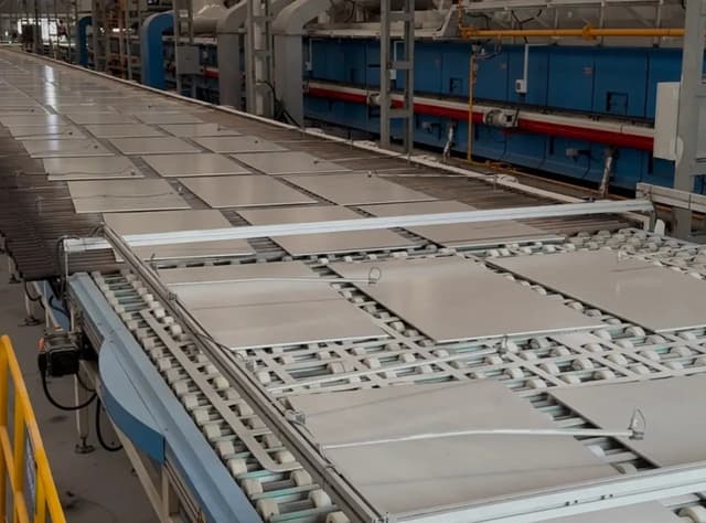 Large-format porcelain tiles moving along an automated production line at Ceraglow