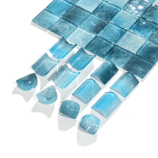 Blue glass mosaic tiles and curved trim pieces for swimming pool applications
