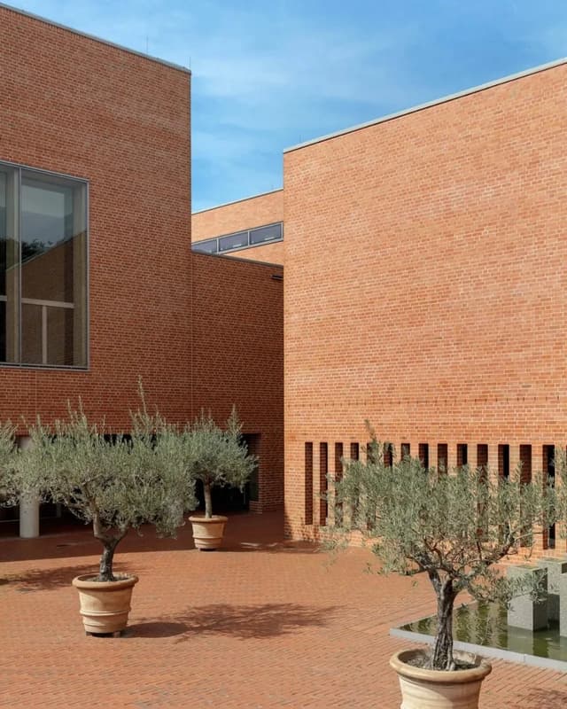 Red brick-look exterior wall tiles on a contemporary courtyard building