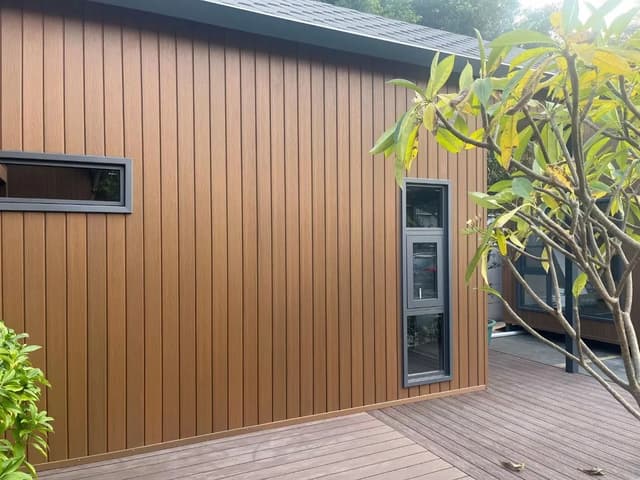 Wood-look WPC wall panels installed on a contemporary exterior facade