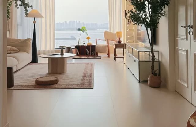 Large-format porcelain tile floor in a bright residential living room