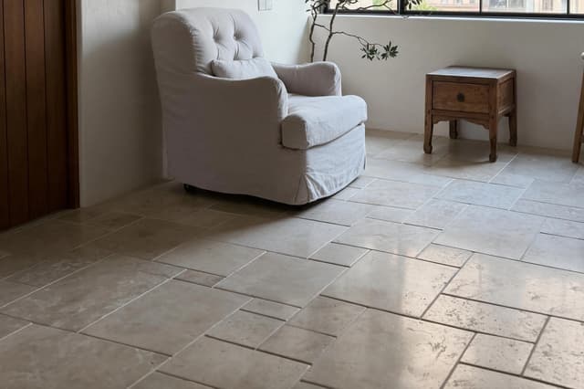 Neutral matte floor tiles in a contemporary Dubai apartment living area