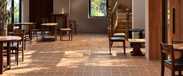 Warm wood-look tile floor in a high-visibility Ho Chi Minh City retail interior