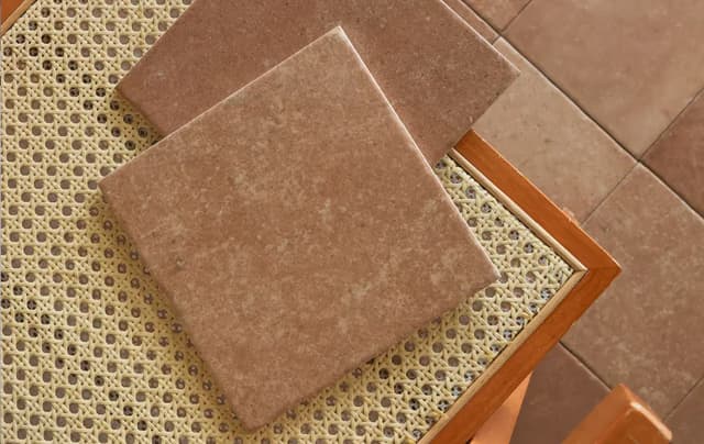 Warm neutral retail tile samples reviewed with timber display materials