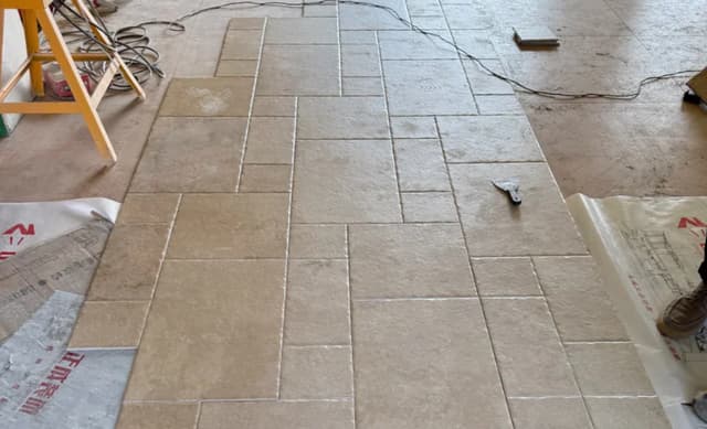 Multi-piece villa floor tile layout reviewed during installation planning