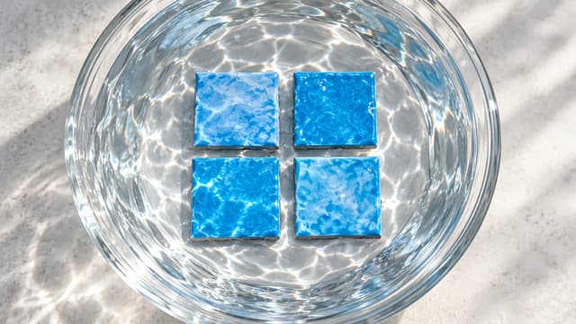 Four blue pool tile samples compared under water and natural daylight