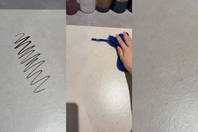 Textured tile surface being checked during a cleaning demonstration