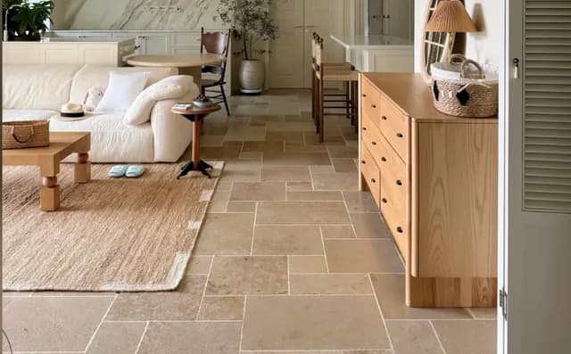 Warm beige rustic floor tiles in an open-plan living and dining interior
