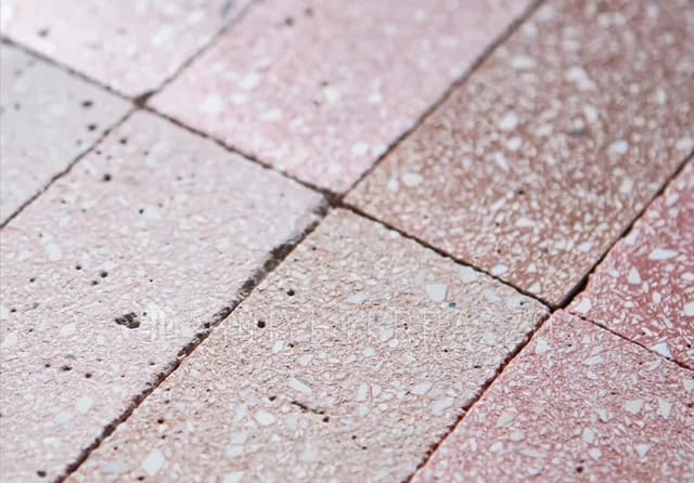 Pink Terrazzo-Look Tile Surface Detail Close-up of pink terrazzo-look rectangular tiles with varied tones and textured surfaces