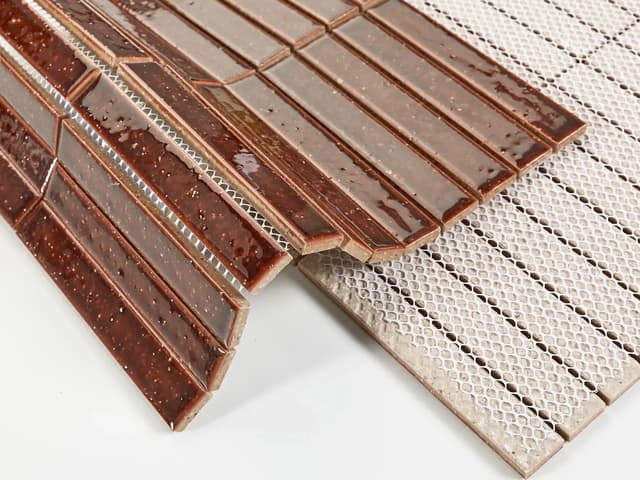 Brown textured glazed subway tile strips on mesh backing with visible joint spacing
