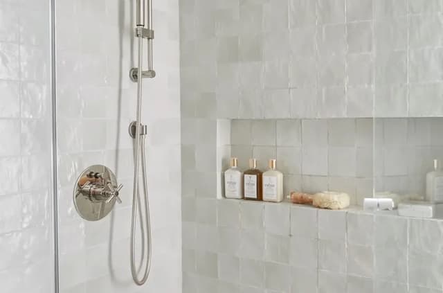 Ceramic Wall Tile in a Shower Wet Area White glazed ceramic wall tiles installed in a shower wet area